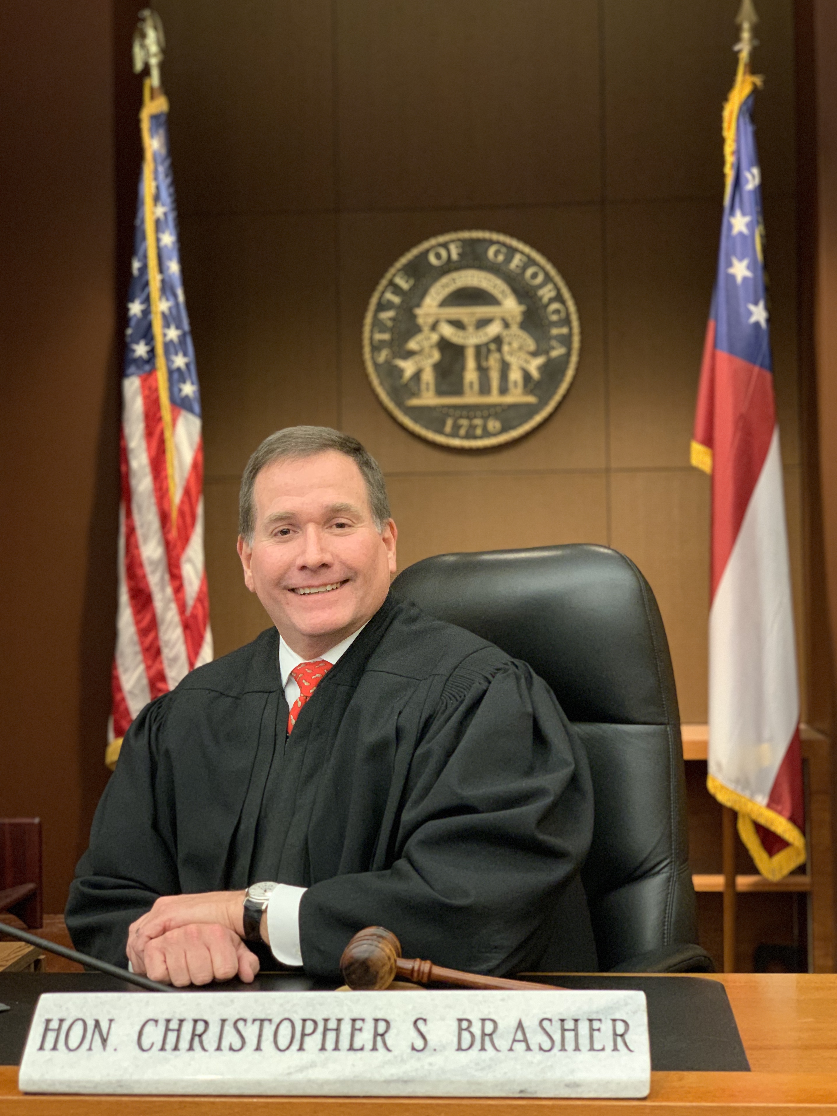 Photo of Judge Brasher posing from the bench in the courtroom 